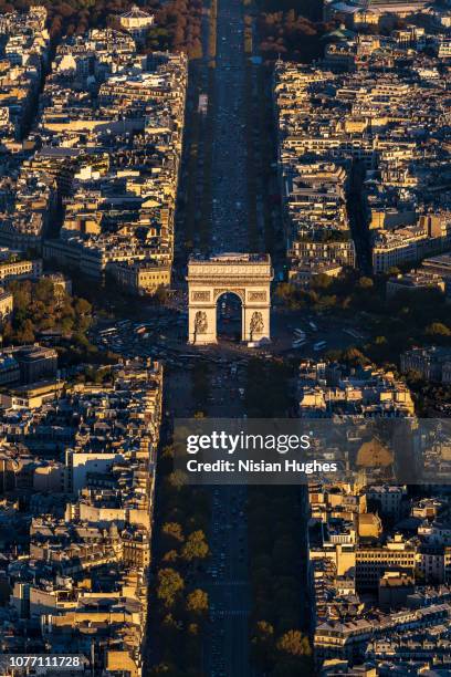 aerial view of arc de triomphe in paris france at sunset - triumphal arch stock pictures, royalty-free photos & images