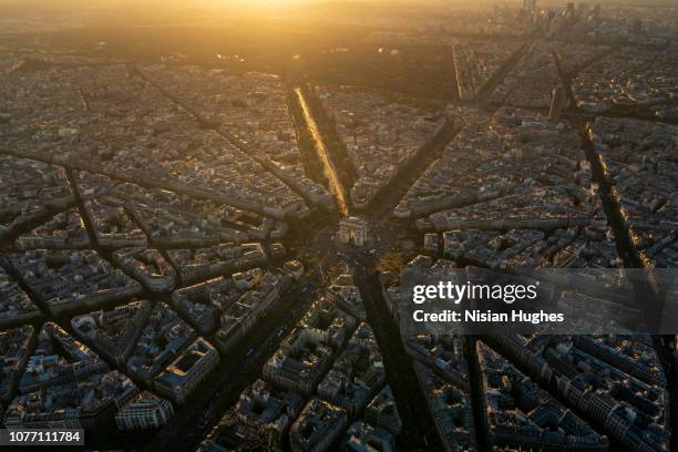 aerial view of arc de triomphe in paris france at sunset - paris aerial stock pictures, royalty-free photos & images