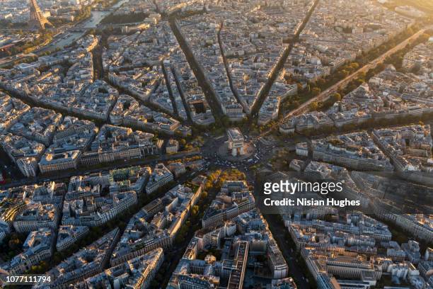 aerial view of arc de triomphe in paris france at sunset - paris stock-fotos und bilder