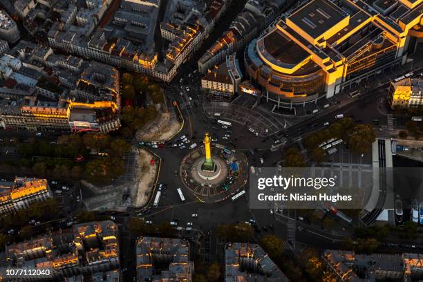 aerial flying over la bastille in paris france, sunset - bastille paris stock-fotos und bilder