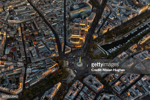 aerial flying over la bastille in paris france, sunset - opéra bastille stock pictures, royalty-free photos & images