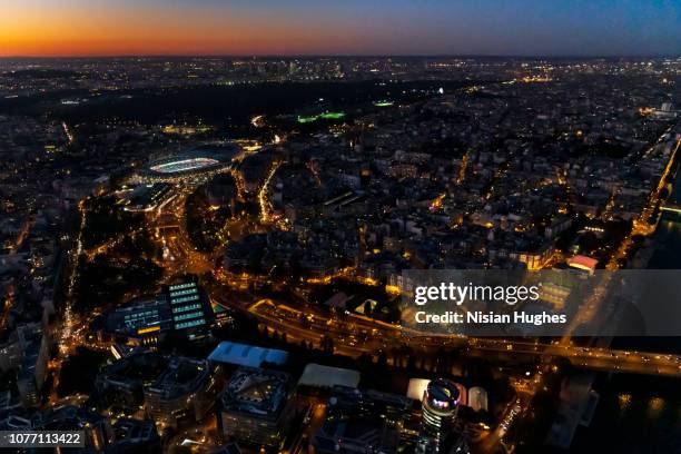 aerial flying over paris france, at night with street lights - france football stock-fotos und bilder
