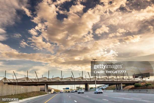 n1 highway with bridge under storm clouds in pretoria - centurion south africa stock pictures, royalty-free photos & images