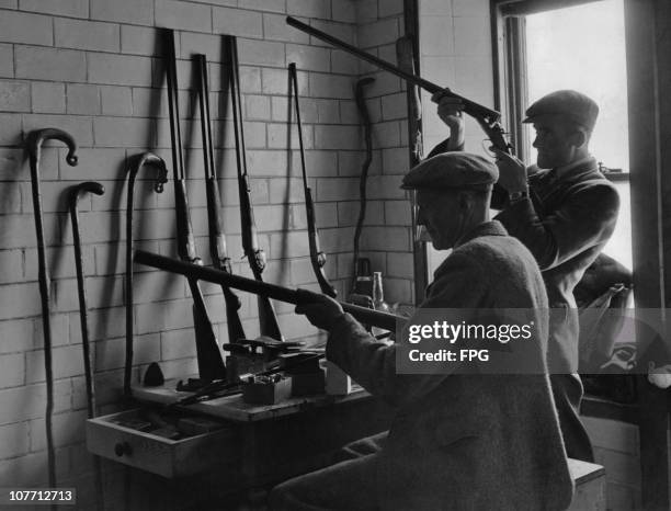 Head ghillie James Edmund and his assistant Robert Simpson cleaning and overhauling guns in preparation for the grouse season at Aberlour House in...