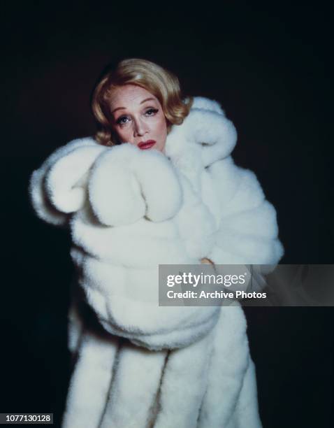 German actress Marlene Dietrich wearing a white fur coat, circa 1955.