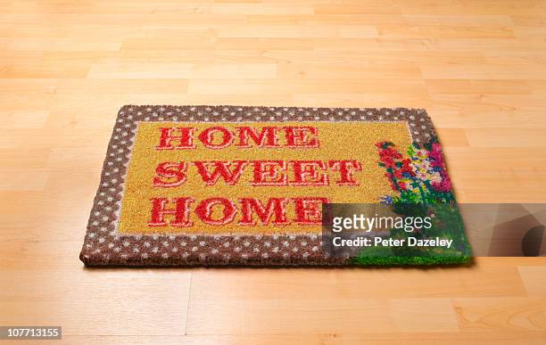 home sweet home doormat on wooden floor - welcome mat stock pictures, royalty-free photos & images