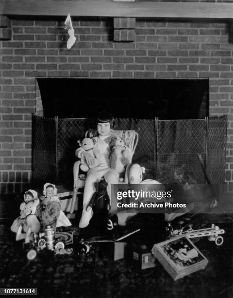 American child actress Baby Peggy, later known as Diana Serra Cary, surrounded by toys at Christmas, circa 1923.