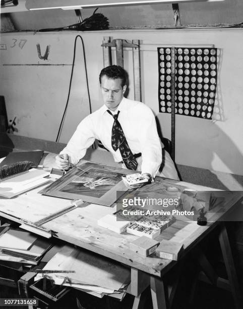 American actor Charlton Heston pursues his hobby of painting in his spare time, circa 1950.