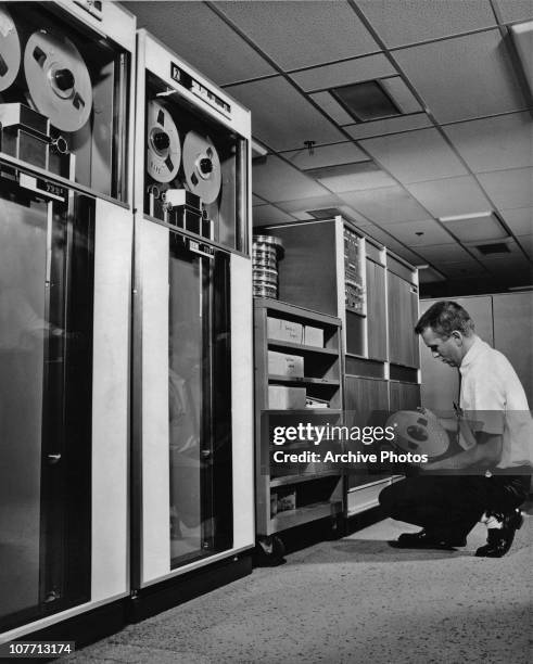 Computer Operator 90s A computer operator with a tape for an IBM 729 data storage system ...
