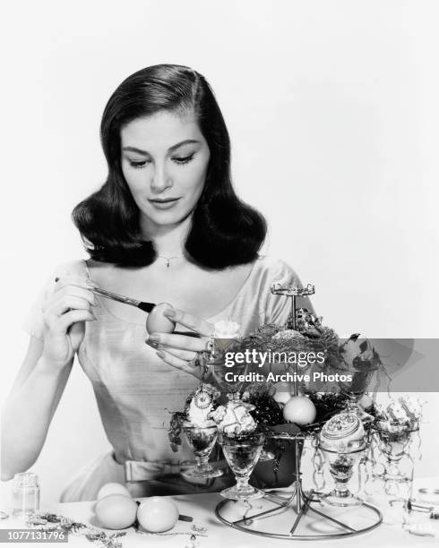 Italian-born actress Pier Angeli decorates Easter eggs, 1958.