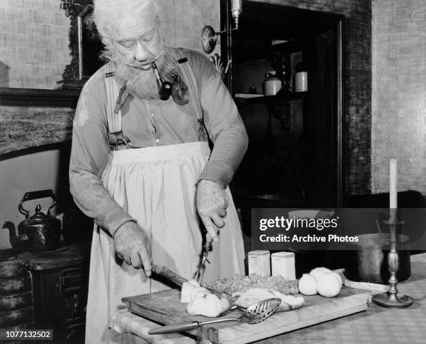 American actor Charles Coburn prepares a haggis for St Andrew's Day on the set of the MGM film 'The Green Years', November 1945. Coburn is of...