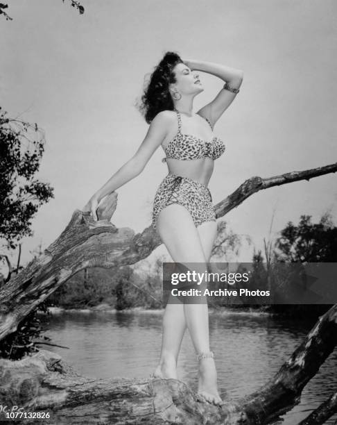 American actress and model Mara Corday wearing a leopard print bikini, 1954.