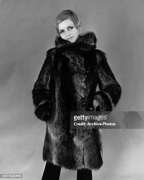 English fashion model Twiggy wearing a fur coat, circa 1975.
