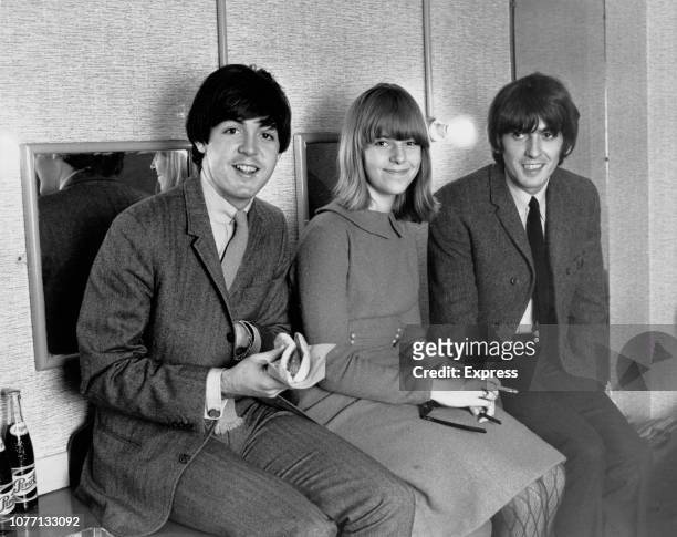 Beatles fan Elizabeth Freeman sitting with her heroes Paul McCartney and George Harrison backstage at the Astoria Cinema in Finsbury Park, London,...