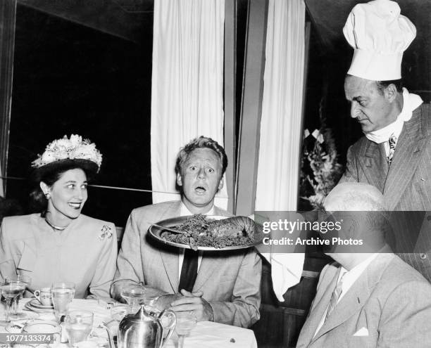 From left to right, Mrs Susan Taurog, actor Van Johnson and director Norman Taurog enjoy a lobster meal at Jack's On The Beach in Santa Monica, Los...