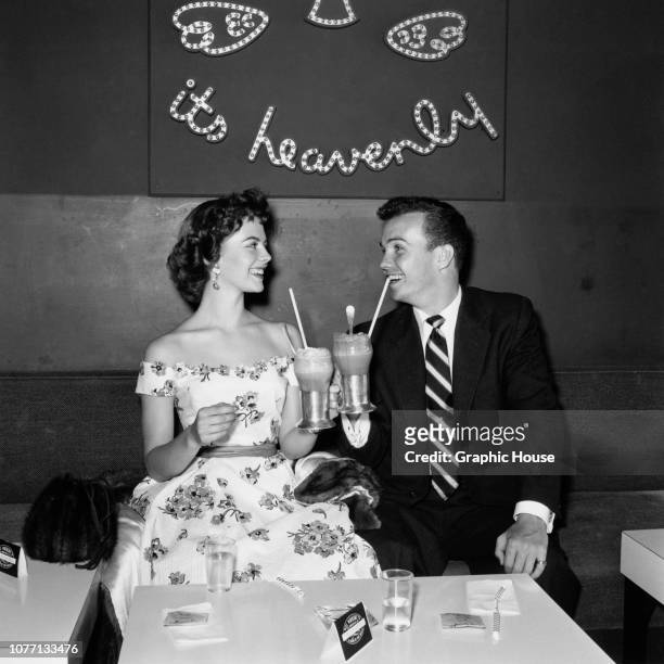 American actors Natalie Wood and Ben Cooper enjoy a milkshake together, 10th June 1955.