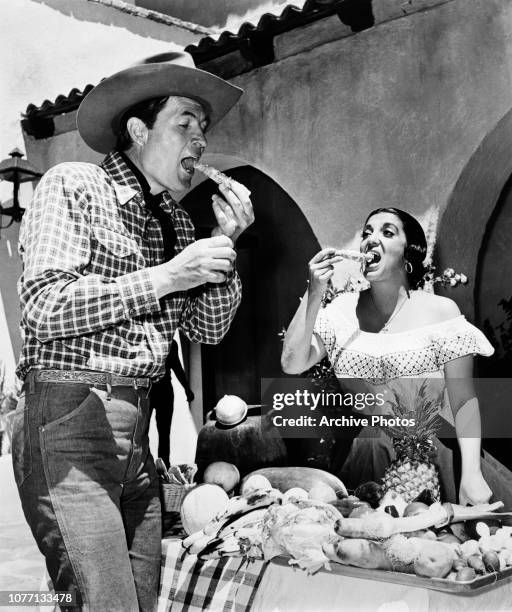 Co-stars Fess Parker and Katy Jurado eating on the set of the western film 'Smoky', circa 1966.