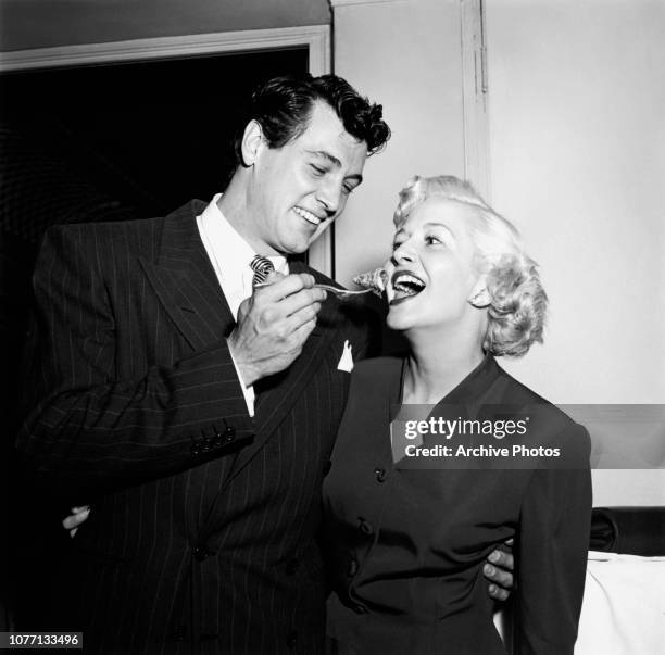 American actor Rock Hudson feeds actress Marilyn Maxwell a treat during a party thrown by Frank Sinatra in the French Room of the Ambassador Hotel in...