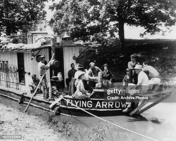 Director Henry Hathaway lines up a shot for the MGM/Cinerama western epic 'How The West Was Won', with actresses Debbie Reynolds and Agnes Moorehead...