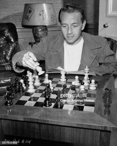Austrian-born American actor Paul Henreid playing chess, circa 1945.