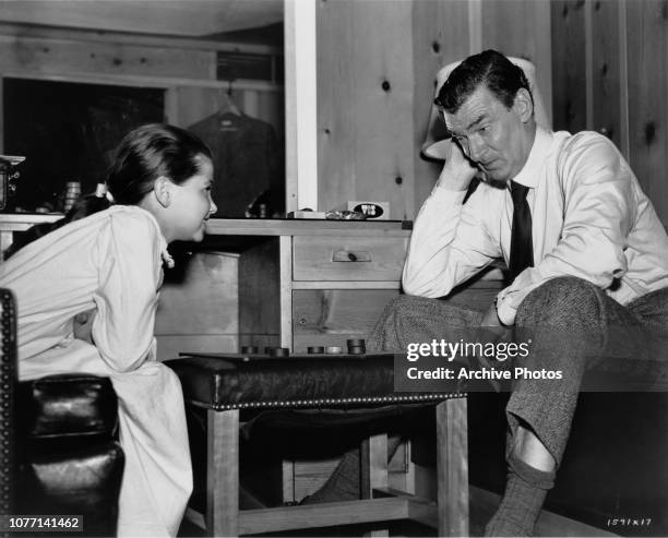 Co-stars Donna Corcoran and Walter Pidgeon playing checkers on the set of the MGM film 'Vicky', later titled 'Scandal at Scourie', 1952.