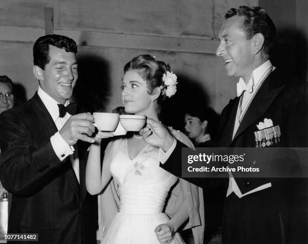 From left to right, actors Dean Martin, Anna Maria Alberghetti and Paul Henreid enjoy a coffee break on the set of the MGM film 'Ten Thousand...