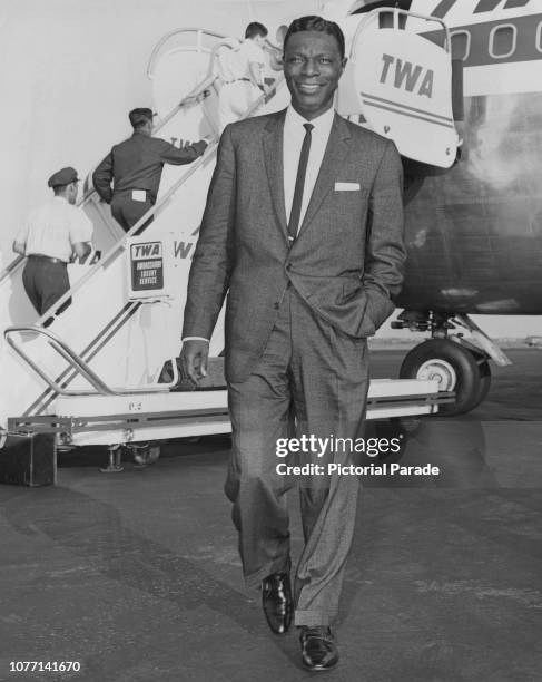 American pianist and singer Nat King Cole arrives at New York International Airport via TWA's Ambassador Luxury Service from Los Angeles, 28th...