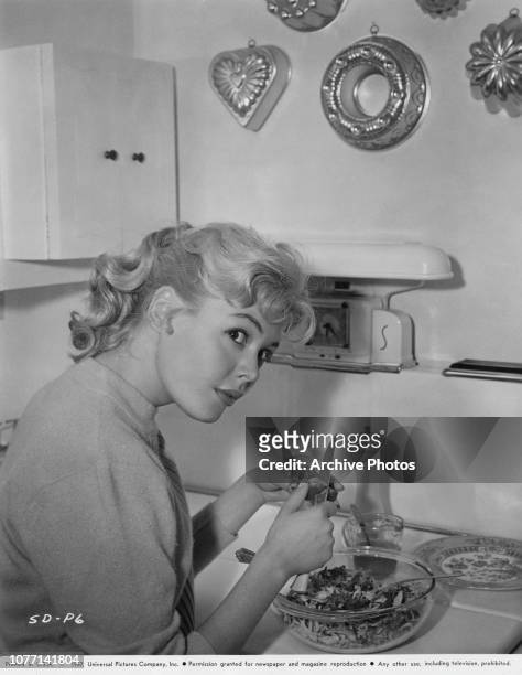 American actress Sandra Dee prepares a salad, 1957.