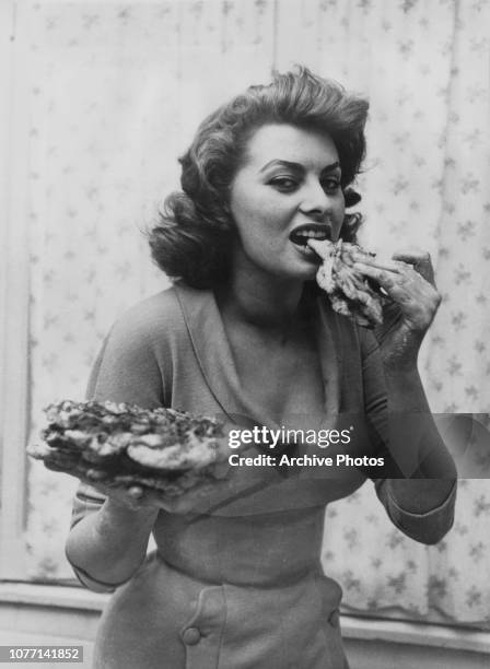 Italian actress Sophia Loren eating pizza, 1954.