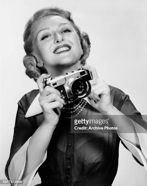 American actress Celeste Holm in her role as photographer Liz Imbrie in the MGM musical film 'High Society', 1956.