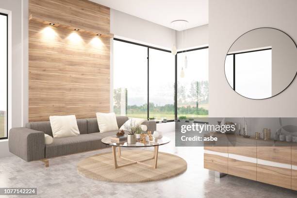 modernes wohnzimmer mit sofa - holzwand stock-fotos und bilder