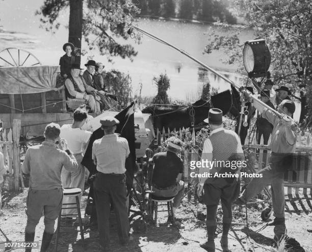 Actors Gene Reynolds, Guy Kibbee, Walter Huston and Beulah Bondi on a wagon in a scene from the MGM Civil War film 'Of Human Hearts', circa 1938.