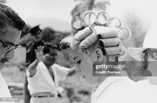 American actress Sue Lyon with her hair in rollers on the set of the MGM film 'The Night of the Iguana', circa 1963.