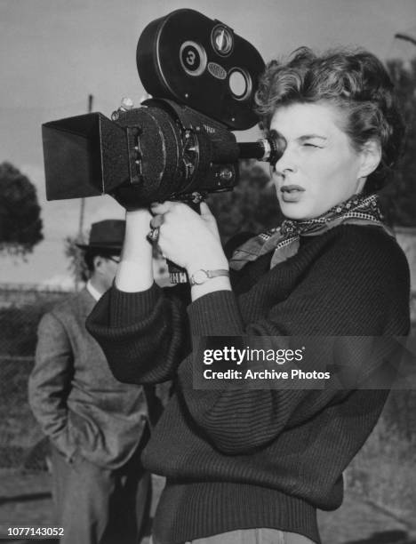 Swedish actress Ingrid Bergman learns how to use a hand-held Arriflex camera between takes of the documentary film 'Siamo Donne' at Santa Marinella...
