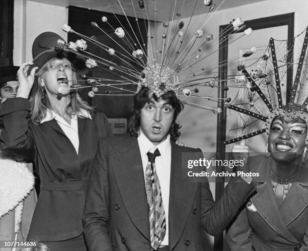 Former Beatle Paul McCartney and his wife Linda try on some of the headdresses from the off-Broadway stage show 'Sgt. Pepper's Lonely Hearts Club...