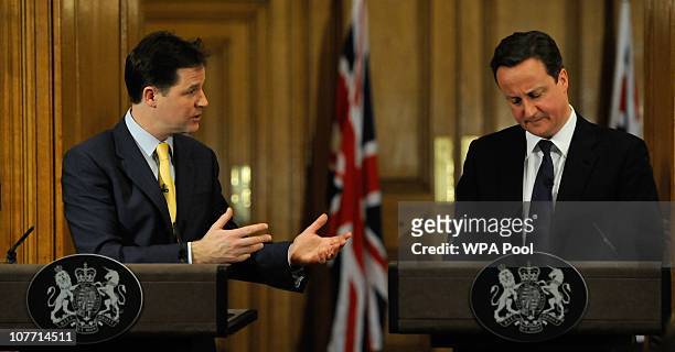 British Deputy Prime Minister, Nick Clegg, gestures towards Prime Minister, David Cameron, during their joint press conference at 10 Downing Street...