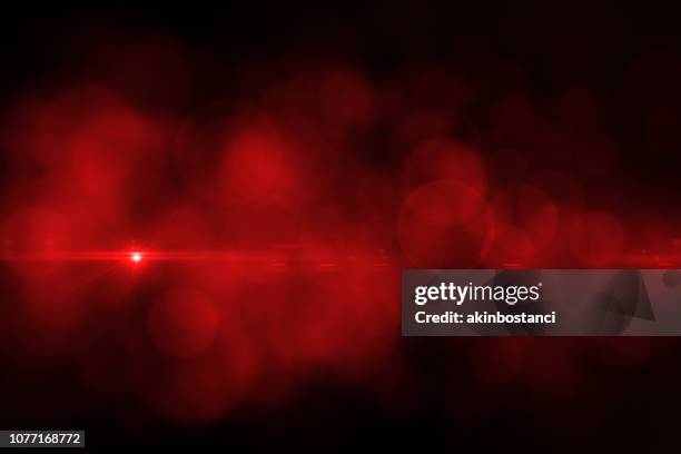 lens flare and bokeh, black background - vermelho imagens e fotografias de stock