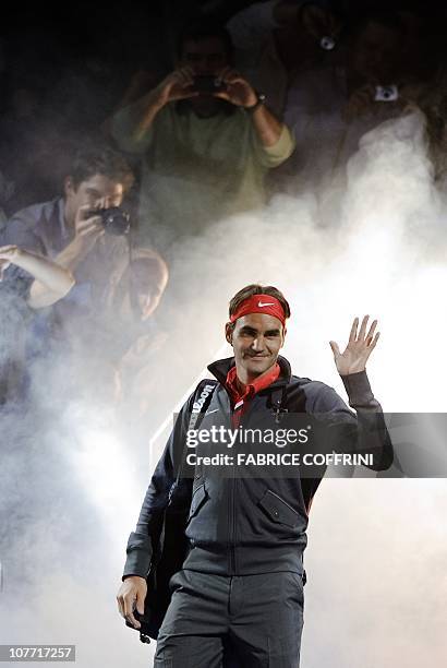 Switzerland's Roger Federer waves to spectators as he arrives to play against Spain's Rafael Nadal during a charity game on December 21, 2010 in...