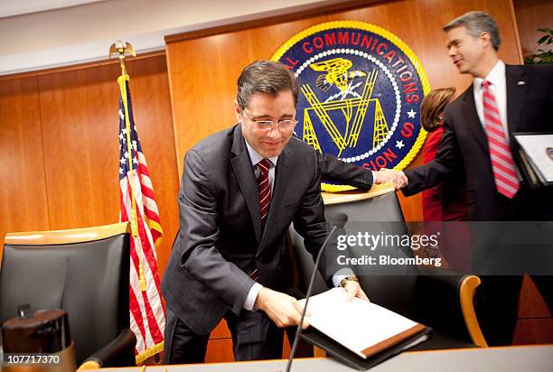 Julius Genachowski, chairman of the U.S. Federal Communications Commission, gathers papers following a hearing on net-neutrality rules at the FCC in...