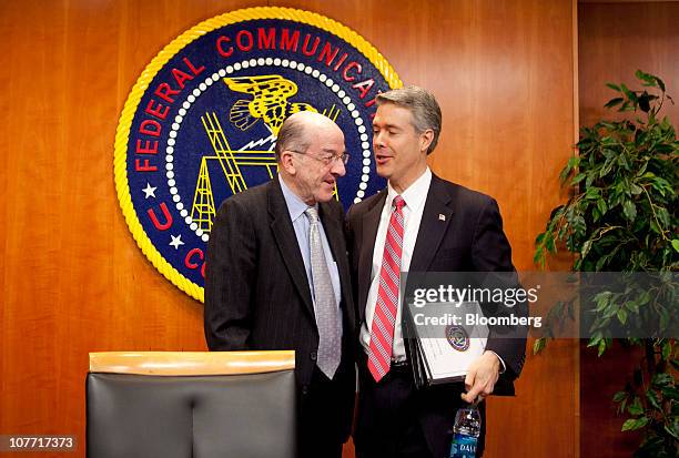 Michael Copps, commissioner of the U.S. Federal Communications Commission, left, speaks to Robert McDowell, commissioner of the FCC, following a...