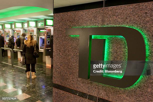 Customers use ATM machines at one of Toronto-Dominion Bank's Canada Trust branches in Toronto, Ontario, Canada, on Tuesday, Dec. 21, 2010....