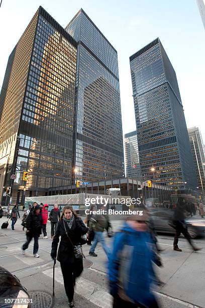 Pedestrians pass by the headquarters building of Toronto-Dominion Bank in Toronto, Ontario, Canada, on Tuesday, Dec. 21, 2010. Toronto-Dominion Bank...