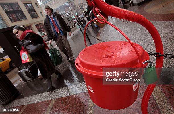 Shoppers walk past a Salvation Army kettle on December 21, 2010 in Chicago, Illinois. As the season winds down donations to Chicago area kettles have...