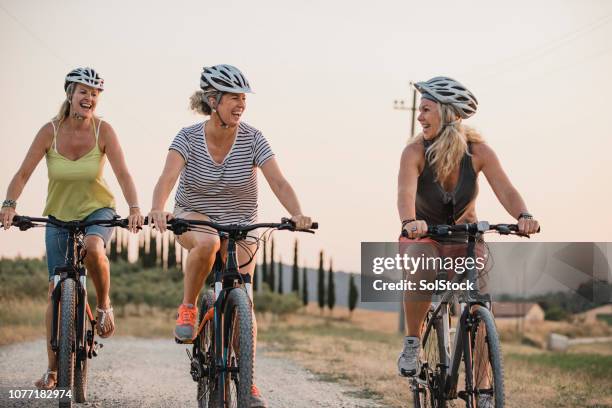 women biking on holiday - only mature women stock pictures, royalty-free photos & images