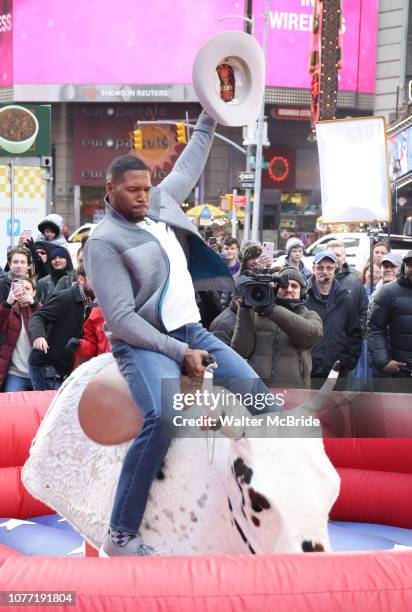 Michael Strahan riding a Mechanical Bull during a Good Morning America filming promoting PBR: Unleash the Beast in Times Square on January 4, 2019 in...