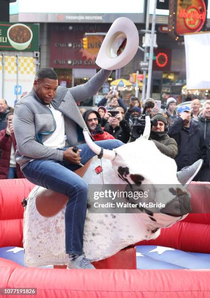 Michael Strahan riding a Mechanical Bull during a Good Morning America filming promoting PBR: Unleash the Beast in Times Square on January 4, 2019 in...