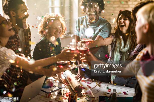 large group of happy entrepreneurs toasting at office party. - office party imagens e fotografias de stock