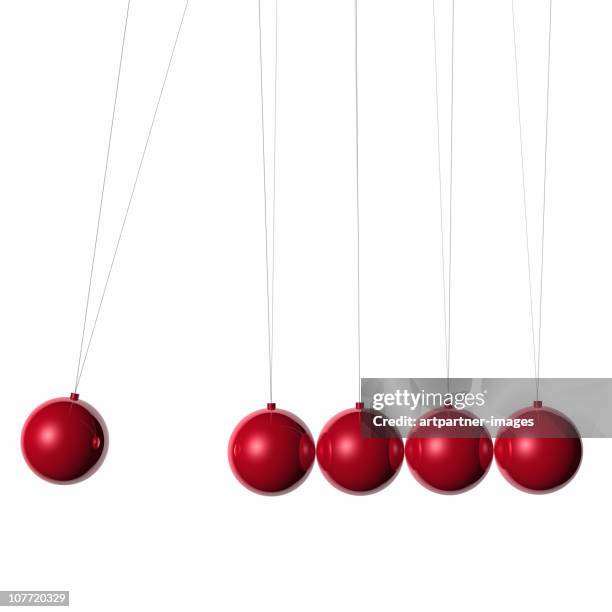 red newton's cradle on white background - newtons cradle stock pictures, royalty-free photos & images