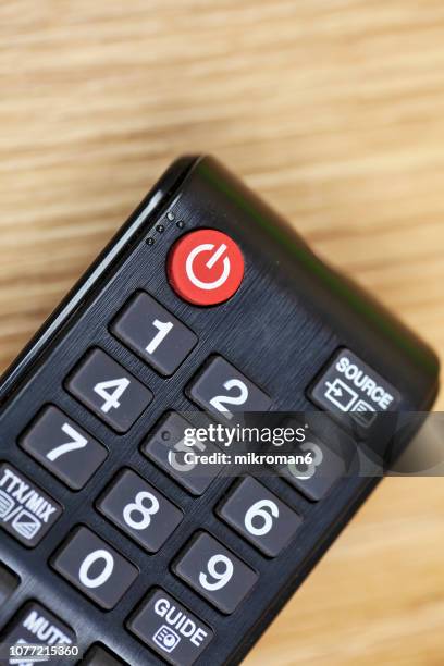 close-up of remote control on table at home - télécommande photos et images de collection
