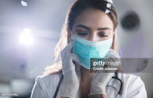 vrouwelijke arts met beschermend masker - face mask protective workwear stockfoto's en -beelden